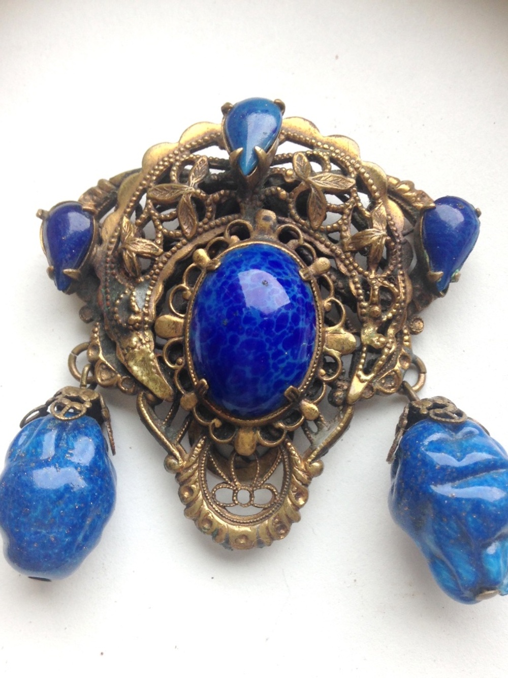 vintage dress clip freeform shape blue glass stone brass with filigree